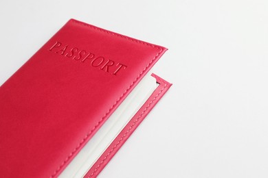 Photo of Passport in red cover on light background, closeup. Space for text