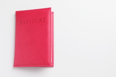 Photo of Passport in red cover on light background, top view. Space for text