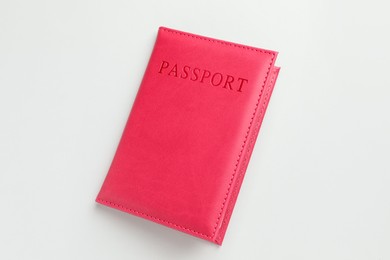 Photo of Passport in red cover on light background, top view