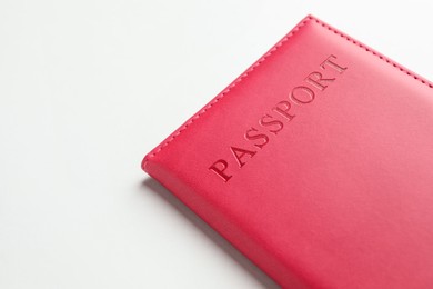 Photo of Passport in red cover on light background, closeup. Space for text