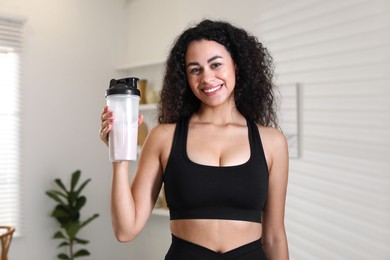 Photo of Beautiful woman with protein shake at home