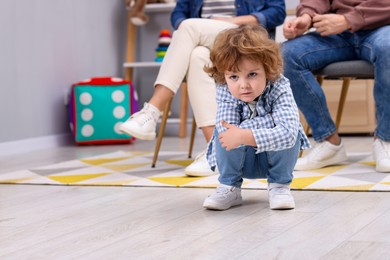 Photo of Resentful little boy and his parents at home, space for text. Family dispute