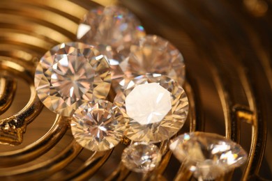 Photo of Beautiful shiny gemstones on golden tray, closeup