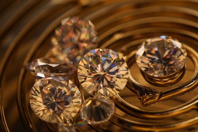 Photo of Beautiful shiny gemstones on golden tray, closeup