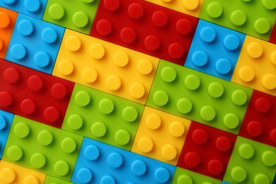 Photo of Constructor toy. Many colorful building blocks as background, top view