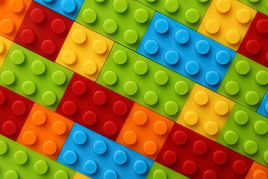 Photo of Constructor toy. Many colorful building blocks as background, top view