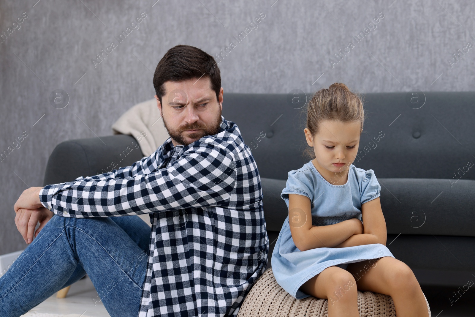 Photo of Resentful little girl and her father arguing at home