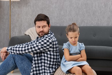 Photo of Resentful little girl and her father arguing at home