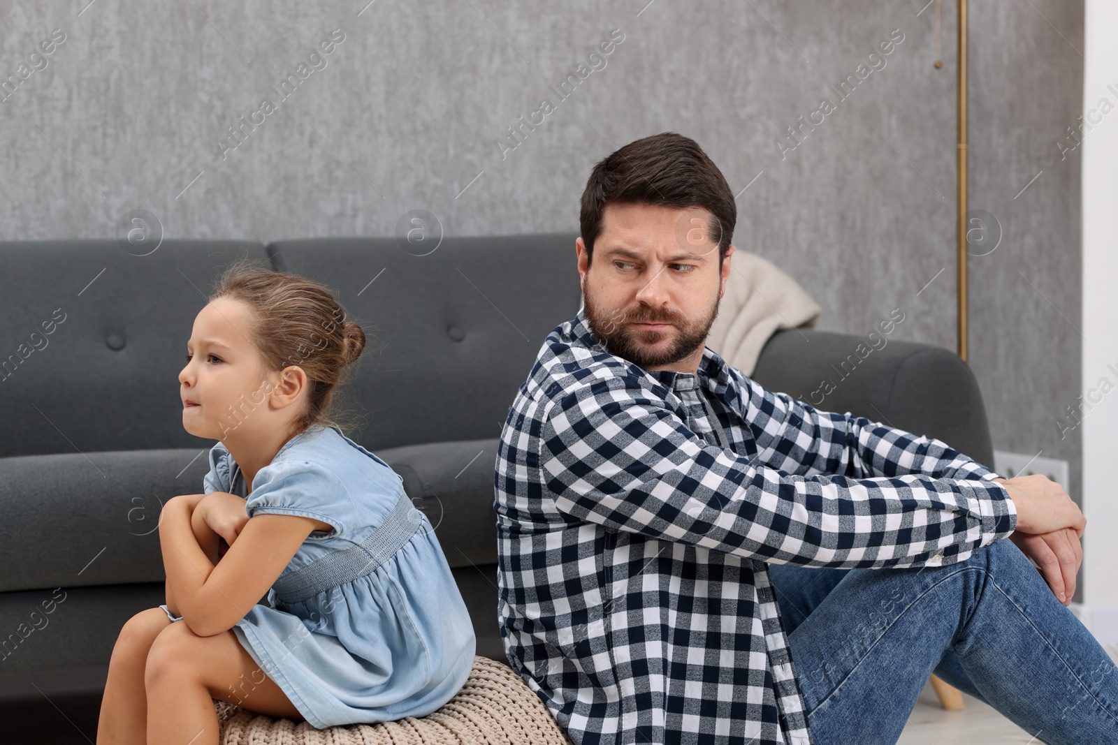 Photo of Resentful little girl and her father arguing at home