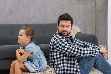 Photo of Resentful little girl and her father arguing at home