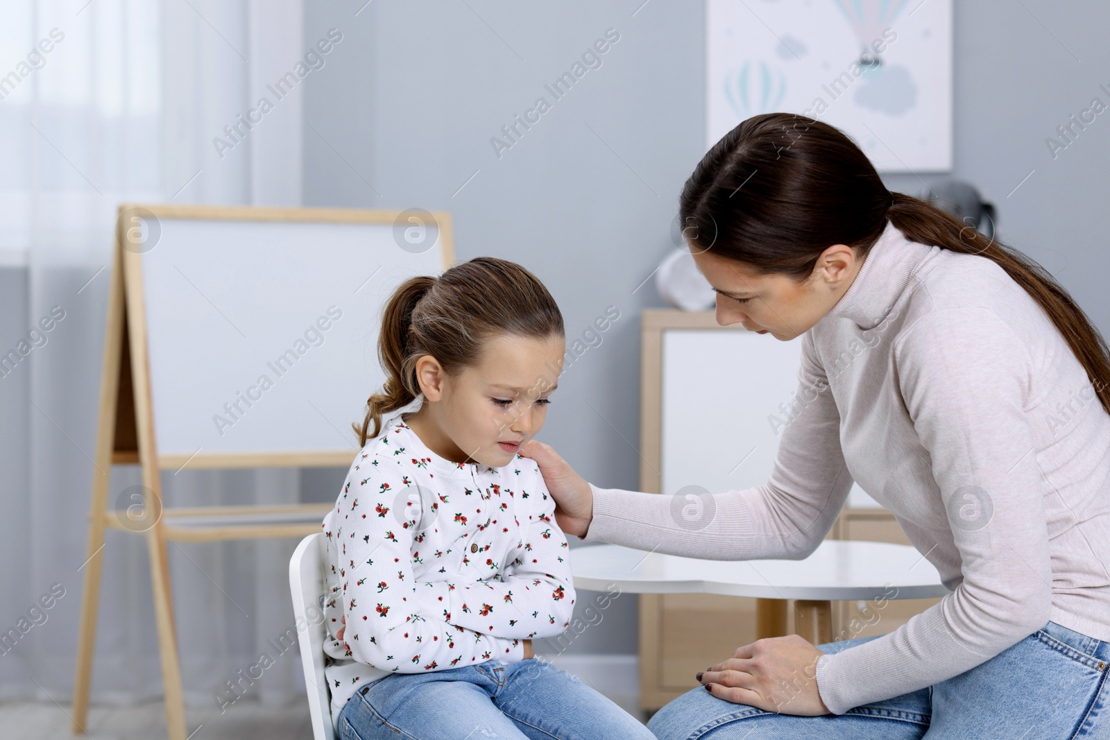 Photo of Resentful little girl and her mother at home