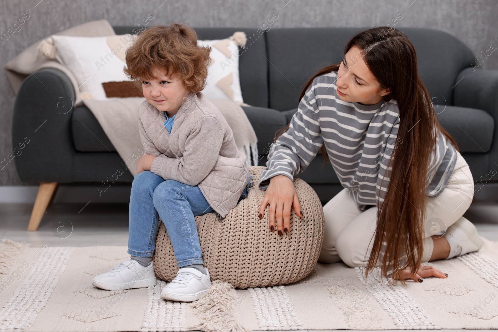 Photo of Resentful little boy and his mother arguing at home