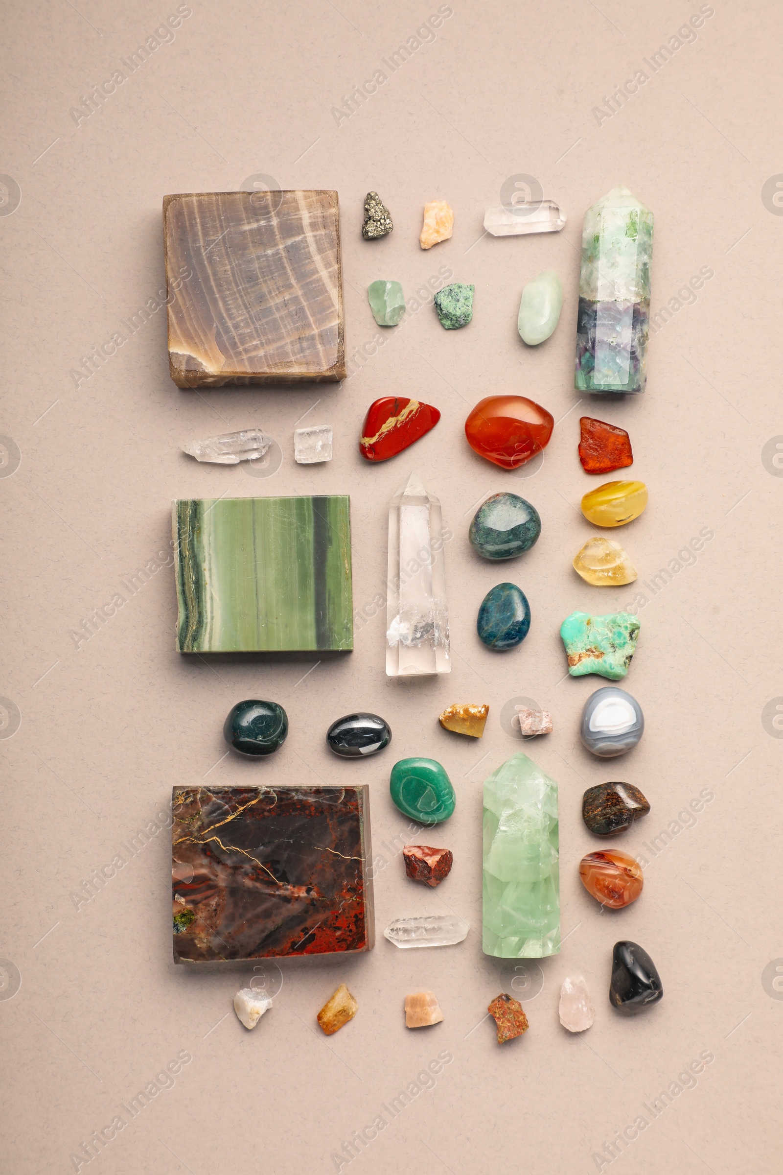 Photo of Different natural gemstones on light background, flat lay