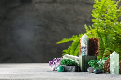 Photo of Natural gemstones and moss on light table. Space for text