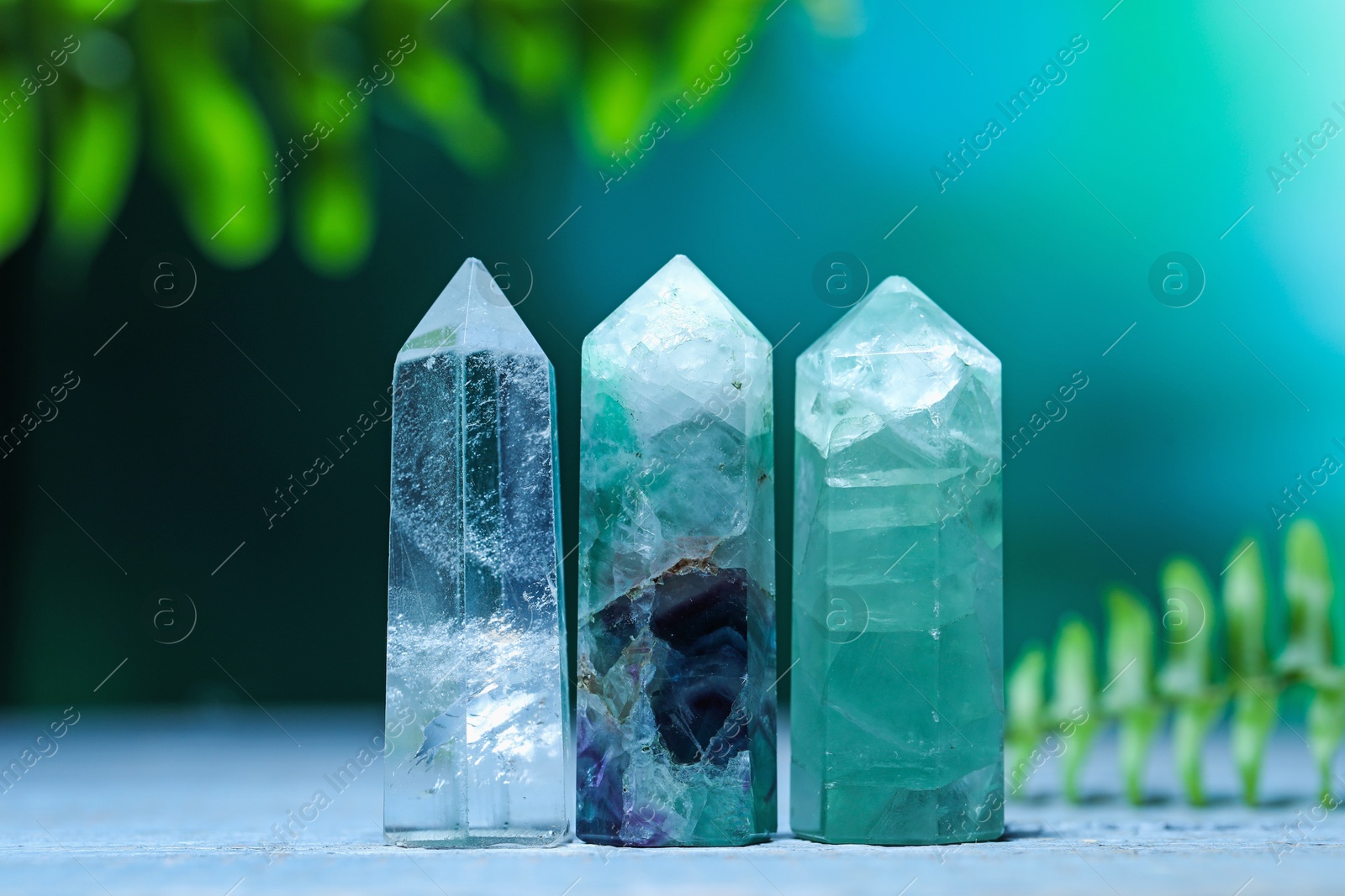 Photo of Beautiful natural gemstones on grey wooden table