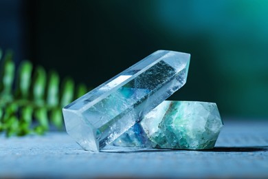 Photo of Beautiful natural gemstones on grey wooden table, closeup