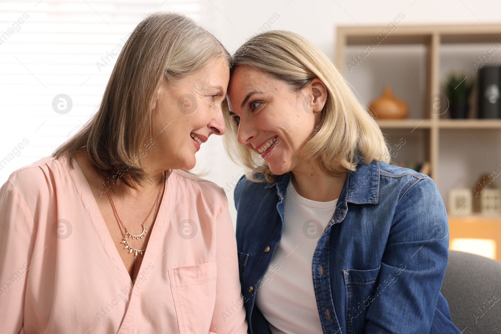 Photo of Smiling daughter and her mother at home