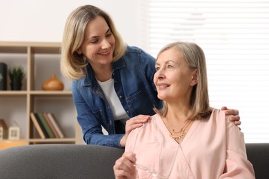 Photo of Smiling daughter and her mother at home