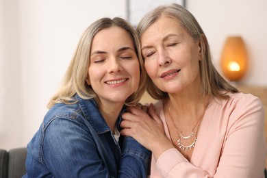 Smiling mother and her daughter at home