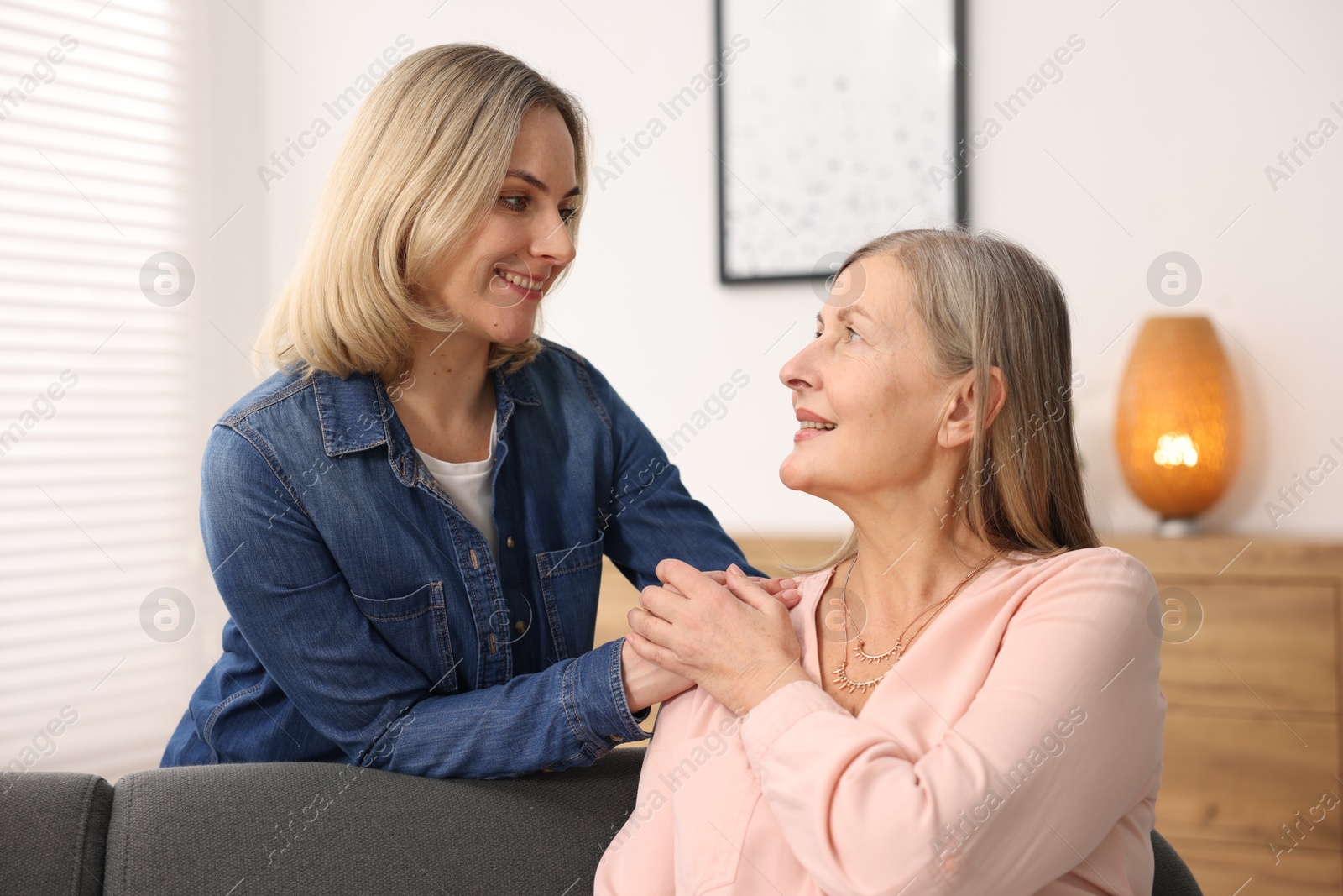 Photo of Smiling mother and her daughter at home