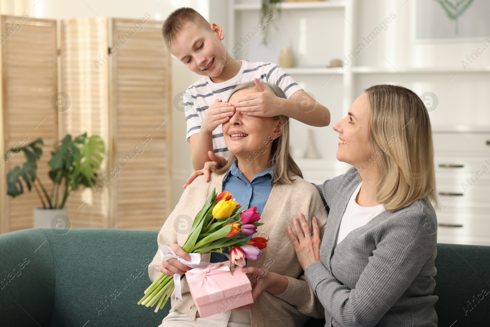 Photo of Mother and son congratulating their happy parent with Mother's Day at home