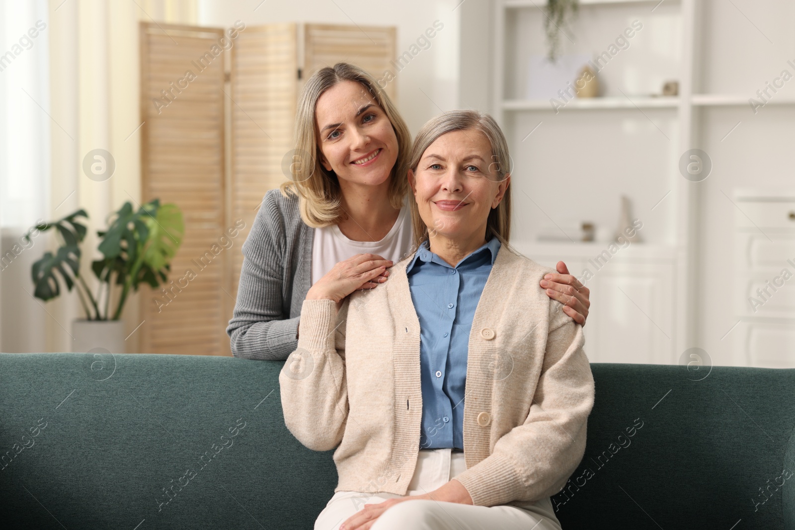 Photo of Family portrait of smiling mother and her daughter at home