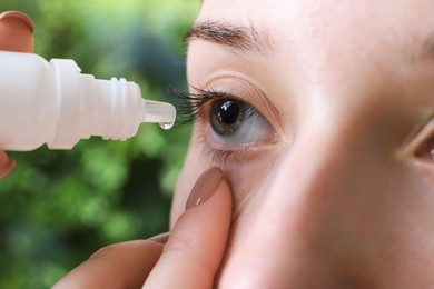 Photo of Allergy treatment. Woman dripping medical drops into eyes on blurred background, closeup