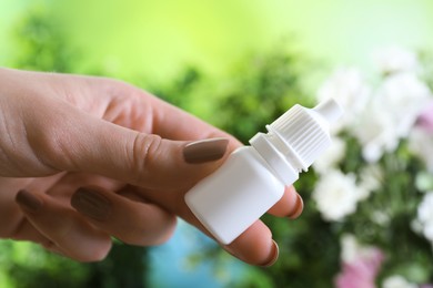 Photo of Allergy treatment. Woman with medical drops on blurred background, closeup