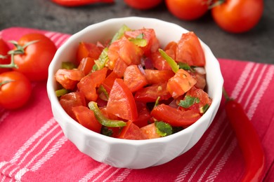 Photo of Delicious salsa (Pico de gallo) in bowl on grey table, closeup