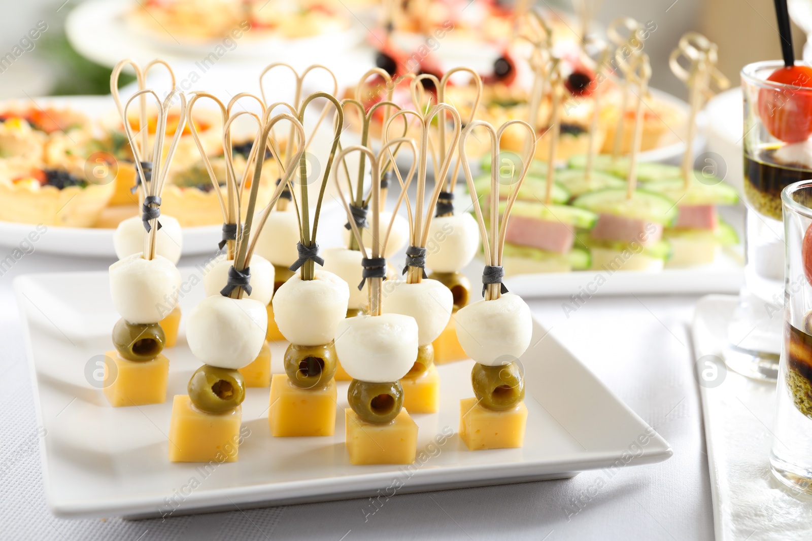 Photo of Many different tasty canapes on white table, closeup