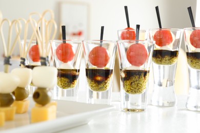 Photo of Many different tasty canapes on white table, closeup