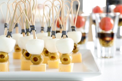 Photo of Many different tasty canapes on white table, closeup