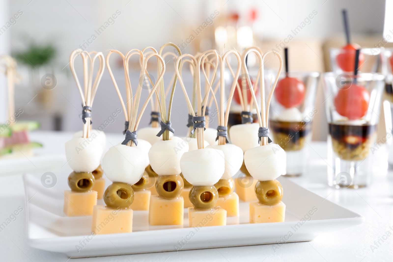 Photo of Many different tasty canapes on white table indoors, closeup