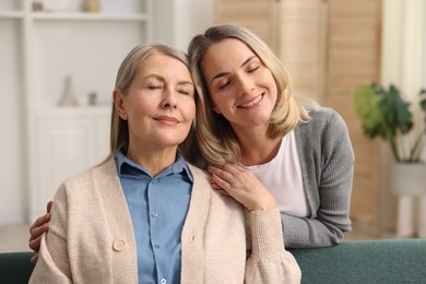 Photo of Smiling daughter and her mother at home