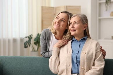 Photo of Smiling daughter and her mother at home