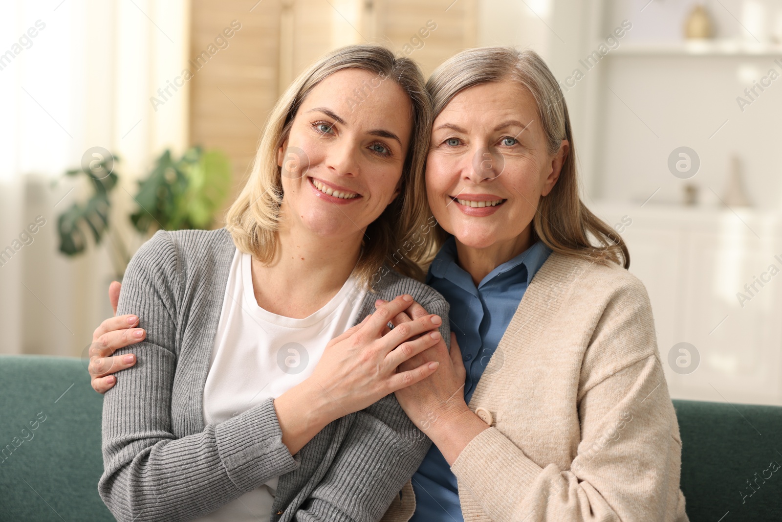 Photo of Family portrait of smiling mother and her daughter at home