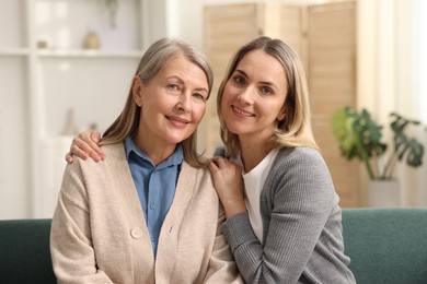 Photo of Family portrait of smiling mother and her daughter at home