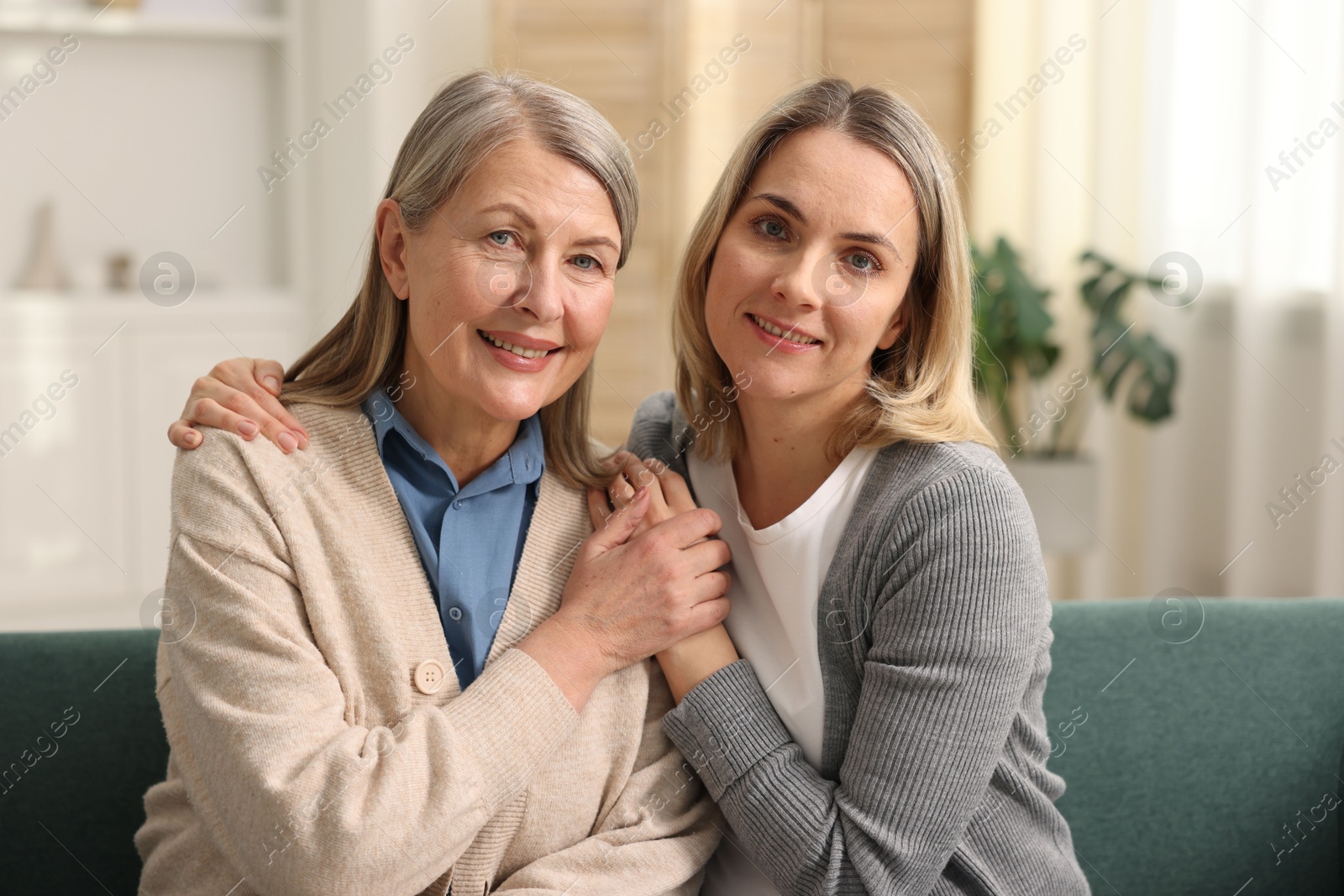 Photo of Family portrait of smiling mother and her daughter at home