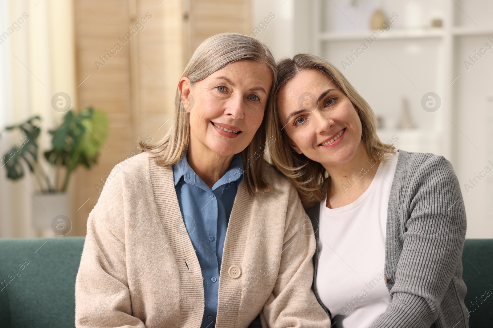 Photo of Family portrait of smiling mother and her daughter at home