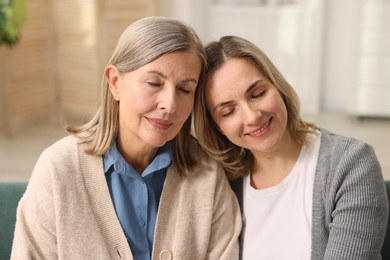 Photo of Smiling daughter and her mother at home