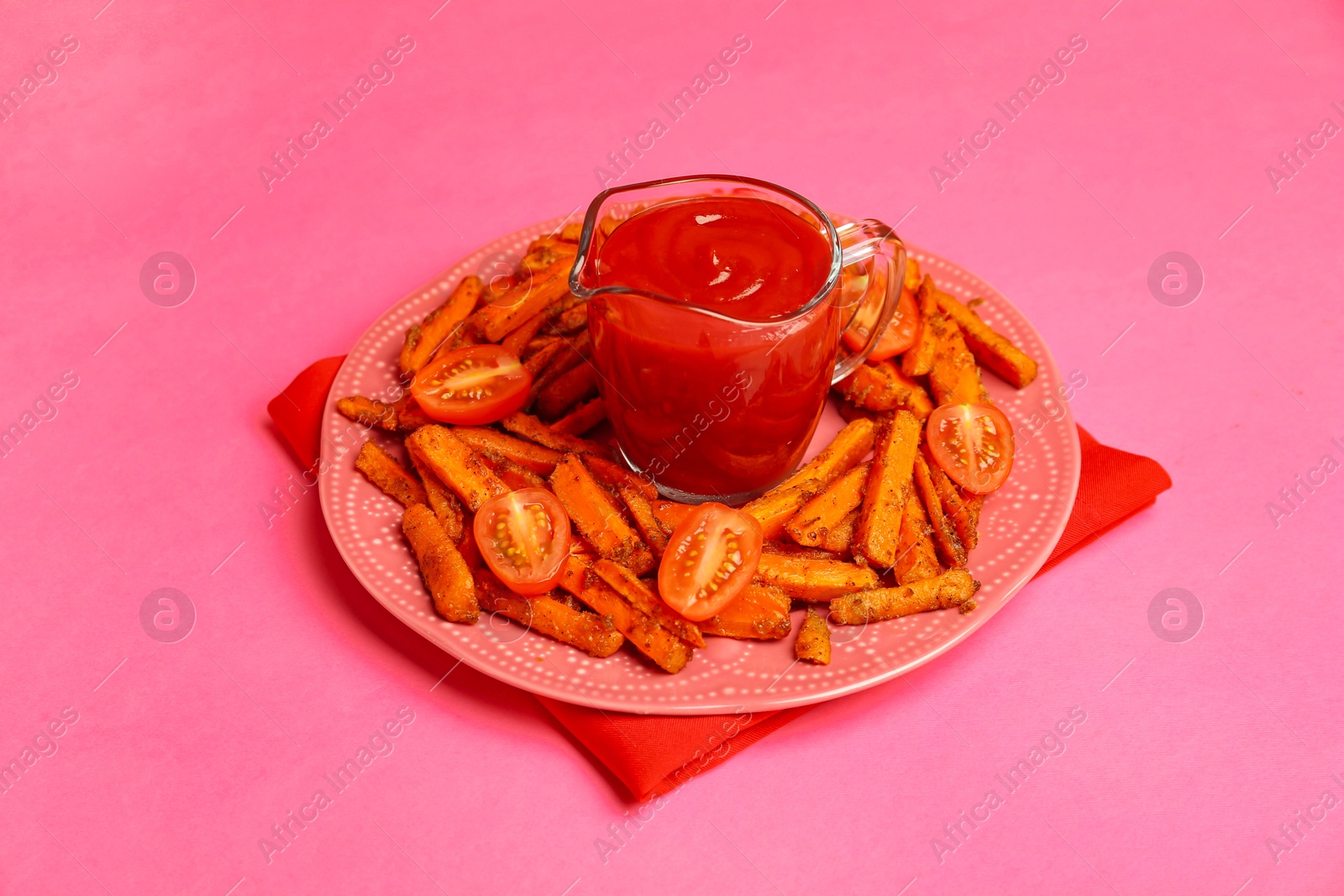 Photo of Tasty ketchup, tomatoes and fried carrots on pink background