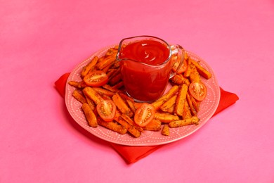 Photo of Tasty ketchup, tomatoes and fried carrots on pink background