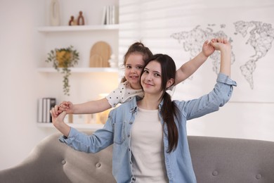 Photo of Portrait of cute little girl and her sister indoors