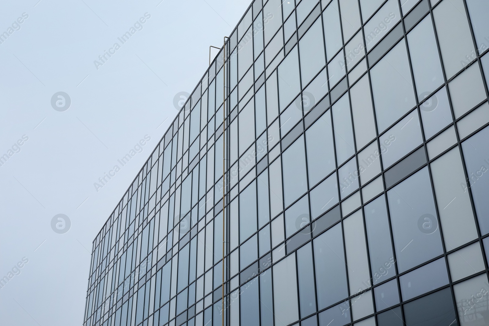 Photo of Modern building with many windows against blue sky