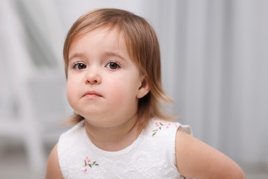 Photo of Cute little baby girl on light grey background