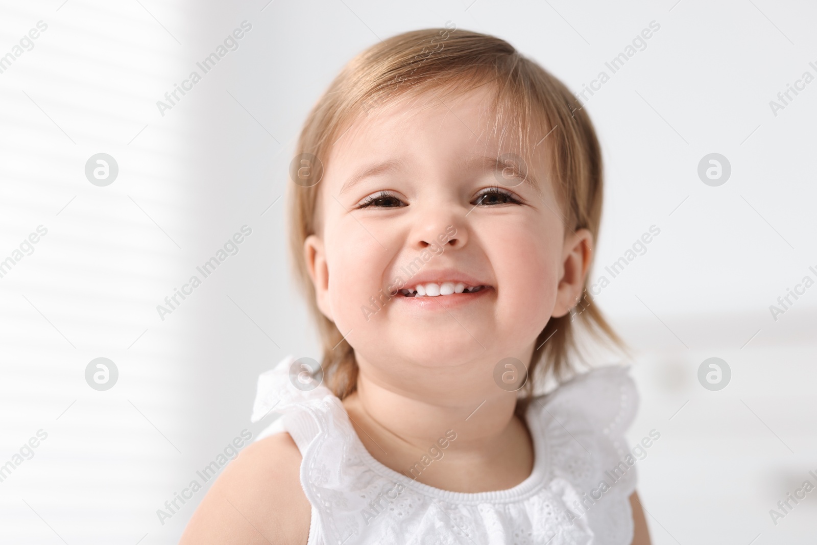 Photo of Portrait of cute little baby girl on light background