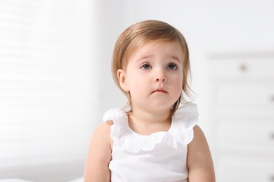 Photo of Portrait of cute little baby girl on light background