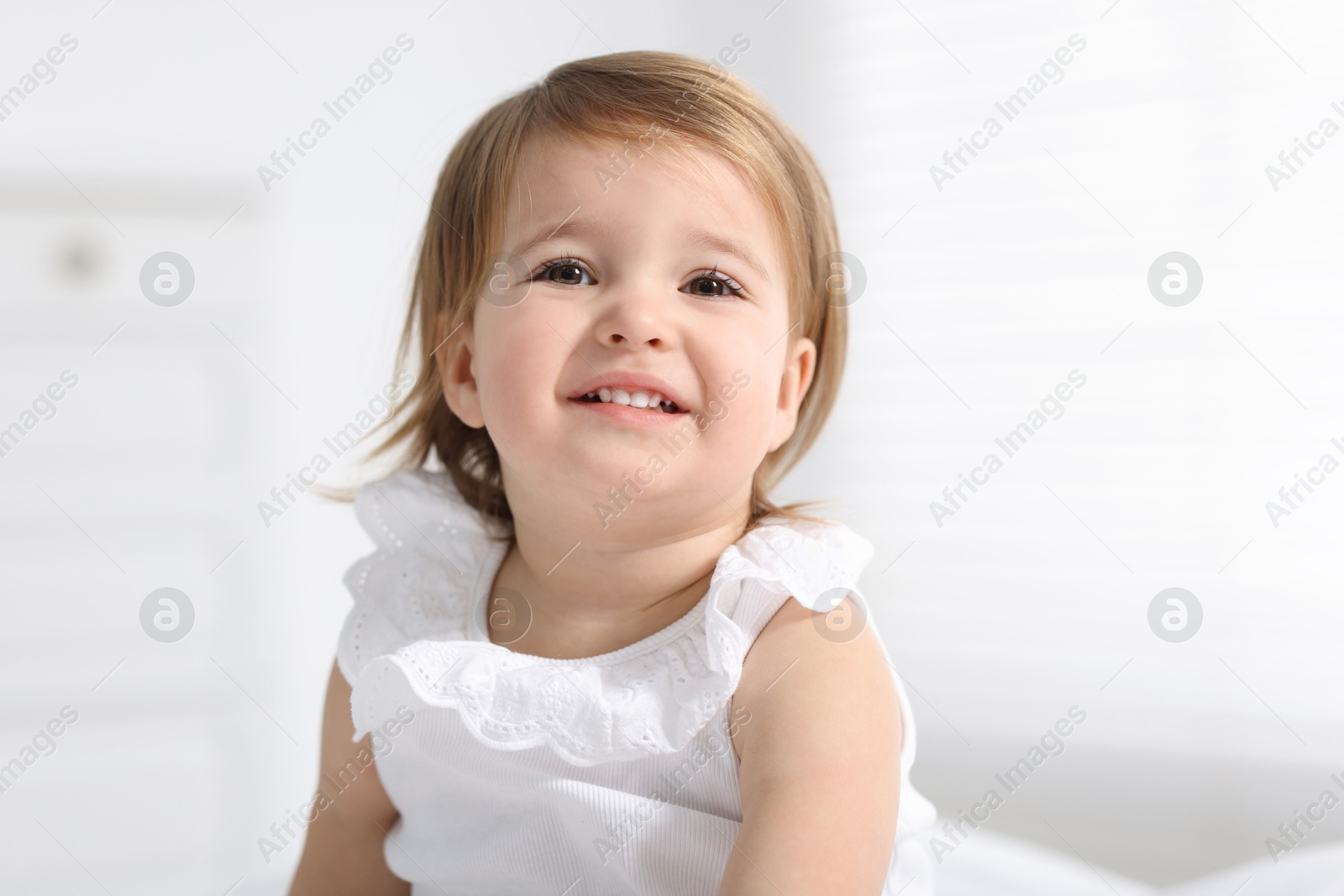 Photo of Portrait of cute little baby girl on light background