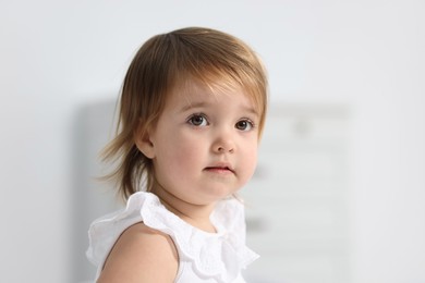 Photo of Portrait of cute little baby girl on light background