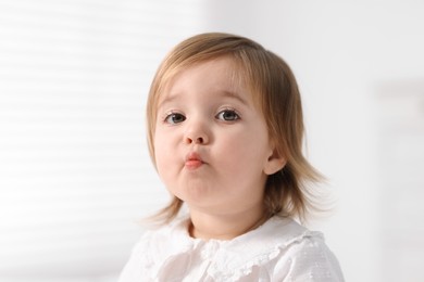 Photo of Portrait of cute little baby girl on light background